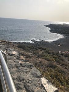 a view of a rocky beach from a bus at Sweet Home San Blas in San Miguel de Abona