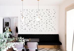 a living room with a black couch and a white wall at Kai 36 - Hotel zwischen Fels und Fluss in Graz