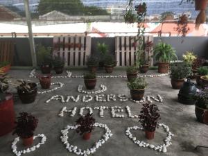 a sign that says antlers order in front of potted plants at Anderson Hotel in Ipoh