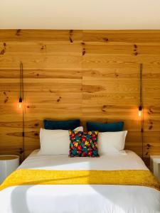- une chambre avec un lit et un mur en bois dans l'établissement Senteurs du Maquis, à Porticcio