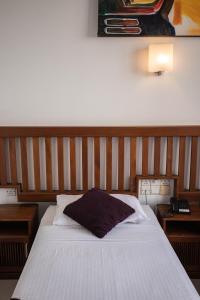 A bed or beds in a room at Port View City Hotel