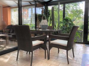 a table and chairs in a living room at Ferienhaus am Wiesenweg in Hosena +20 photos