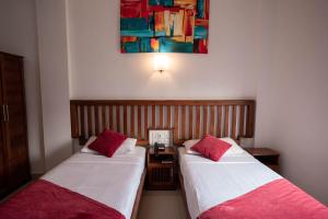A bed or beds in a room at Port View City Hotel