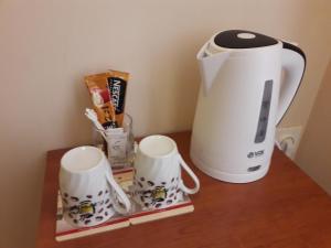 a coffee maker and two mugs on a table at Brankov Konak in Niš
