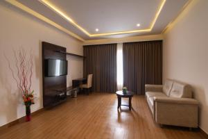 a living room with a couch and a television at The Liverpool Hotels Marathahalli, Outer Ring Road in Bangalore