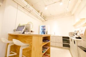 a kitchen with a desk with a computer on it at SSS Life Hotel in Tainan