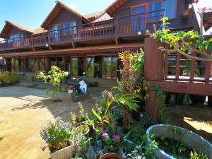 a house with a scooter parked in front of it at Molyka Lodge in Banlung