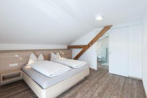 a bedroom with a bed with white pillows on it at Haus Pipperger in Cadipietra