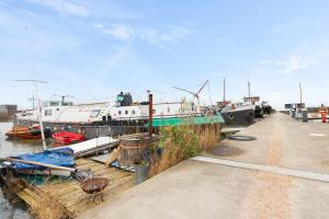 a group of boats docked at a dock at B&B Houseboat Amsterdam in Amsterdam