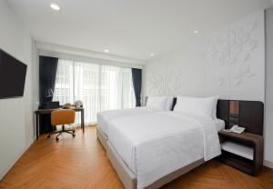 Una cama o camas en una habitación de Amanta Hotel & Residence Sathorn