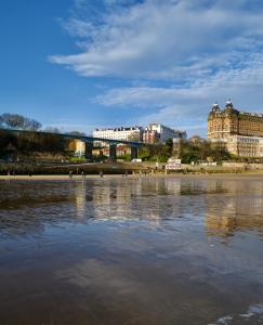 a body of water with buildings in the background at Bike & Boot Inns Scarborough - Leisure Hotels for Now in Scarborough