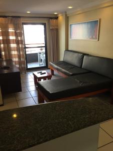a living room with a couch and a table at Porto de Iracema - Fortaleza houses in Fortaleza
