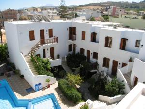 an aerial view of a white building with a swimming pool at Blue Sea Hotel Apartments in Rethymno Town