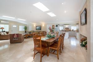 a dining room and living room with a table and chairs at Kailua Beachside home in Kailua