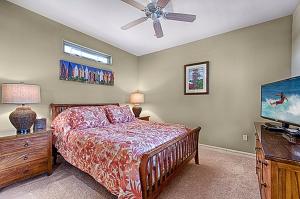 a bedroom with a bed and a flat screen tv at Waikoloa Beach Villas O-33 condo in Waikoloa +11 photos