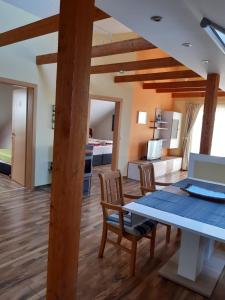 a dining room and living room with a table and chairs at Ferienwohnung Neumeister in Bad Gleichenberg