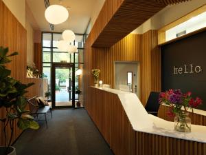 an office lobby with a reception counter and flowers at Student Castle Studio Apartments - Free parking in Bath