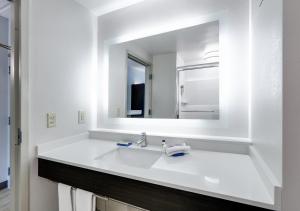 a white bathroom with a sink and a mirror at Holiday Inn Express Hotel & Suites Dublin by IHG in Dublin
