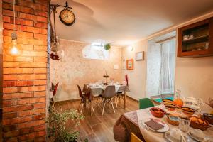 a dining room with a table and a brick wall at B&B Borgo Antico in Papasidero