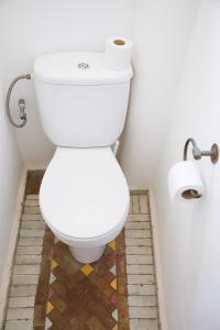 a bathroom with a toilet with two rolls of toilet paper at Dar Liouba Hotel in Essaouira