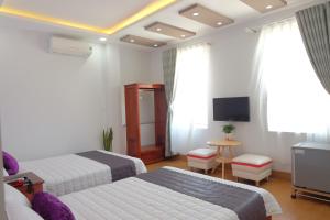 Postel nebo postele na pokoji v ubytování TH Quy Nhơn Hotel