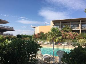 a swimming pool in front of a building at ZenGarden Pool,3bedrooms,lit bébé Beach800m,box&wifi in Antibes