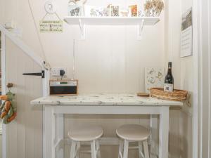 a small kitchen with a table and stools at 31 Outgang Road in Pickering