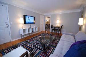 a living room with a couch and a flat screen tv at Brookwood Courtyard by BCA Furnished Apartments in Atlanta