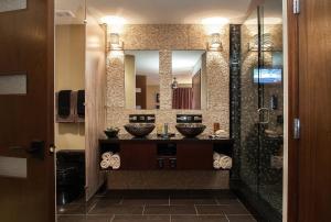a bathroom with two sinks and a mirror at Holiday Inn Club Vacations at Desert Club Resort, an IHG Hotel in Las Vegas