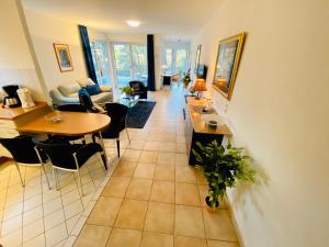 eine Küche und ein Wohnzimmer mit einem Tisch und Stühlen in der Unterkunft Villa Seepark - Ferienwohnung 9 in Heringsdorf