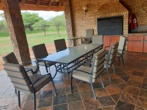 a dining room table and chairs in a room at Makhato Bush Lodge 86 in Bela-Bela