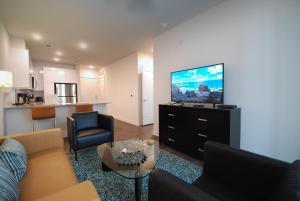 a living room with a couch and a flat screen tv at Spectacular Suites by BCA Furnished Apartments in Atlanta
