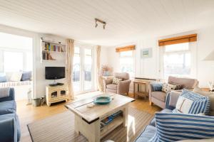 a living room with a couch and a table at Shore Cote, Thorpeness in Thorpeness