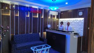 two people standing at a bar in a room at Presken Hotels @ Freedom Way, Lekki in Lekki