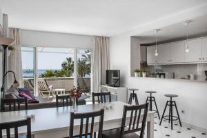 a kitchen and living room with a table and chairs at Beachfront in Benalmadena by Costarentals - Ref 70 in Benalmádena