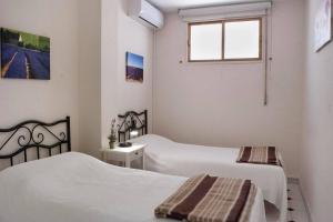 a bedroom with two beds and a window at Beachfront in Benalmadena by Costarentals - Ref 70 in Benalmádena