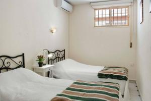 a bedroom with two beds and a window at Beachfront in Benalmadena by Costarentals - Ref 70 in Benalmádena