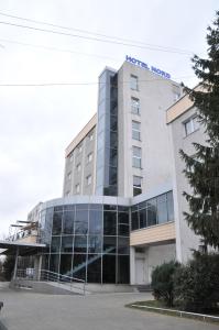 
a large building with a clock on the front of it at Hotel Nord in Ploieşti
