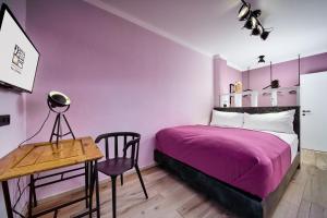a bedroom with a bed and a table and a desk at Salzburg Topside Apartments in Salzburg