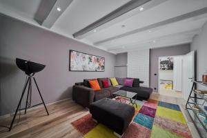 a living room with a couch and a camera at Salzburg Apartments in Salzburg