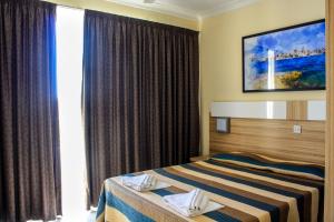 Postel nebo postele na pokoji v ubytování Coral Hotel