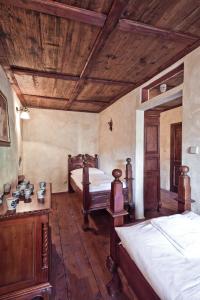 a bedroom with two beds and a wooden ceiling at Penzion Baroko in Český Krumlov