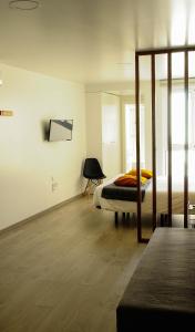 een slaapkamer met een bed en een stoel erin bij Aveiro Rossio Apartments in Aveiro
