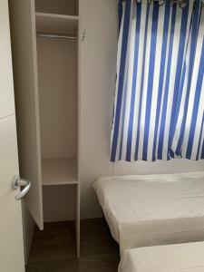 a small bedroom with a bed and a window at Villa Granja Sol in São Félix da Marinha
