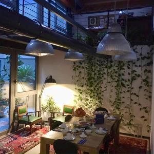 a dining room with a table and some plants on the wall at Loft Verona in Verona
