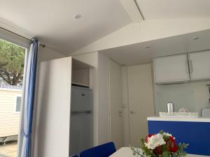 a kitchen with a mirror and a table with a vase of flowers at Villa Granja Sol in São Félix da Marinha +7 photos