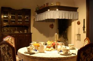 a dining room table with a candle on top of it at B&B Villa al Lago in Farra dʼAlpago