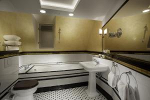 a bathroom with a sink, toilet and bathtub at Hotel Paris Prague in Prague