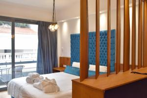 a hotel room with a bed with towels on it at Lycabettus Exclusive Apartments in Athens