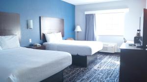 Habitación de hotel con 2 camas y ventana en Magnolia Inn and Suites Olive Branch, en Olive Branch